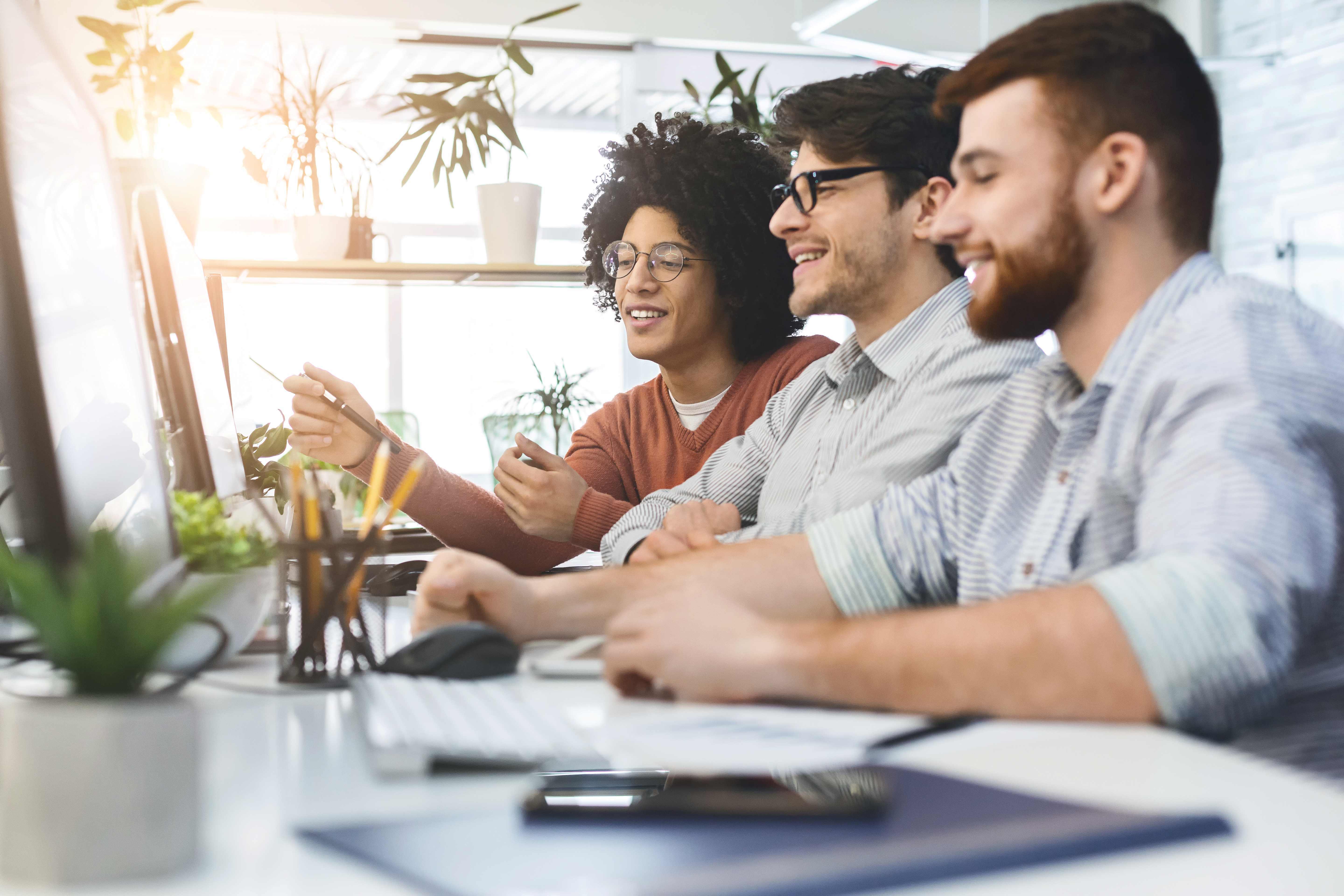 Programmers cooperating at IT company developing apps